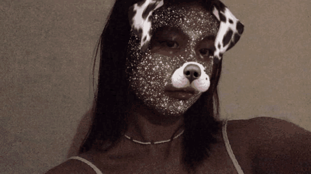 a woman wearing a dalmatian mask with stars on her face