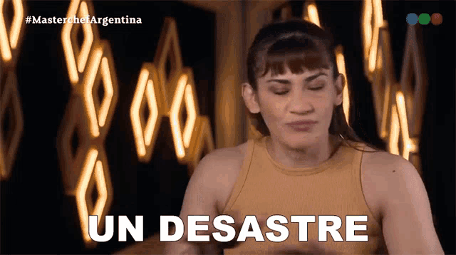 a woman in a yellow tank top is making a funny face and says un desastre