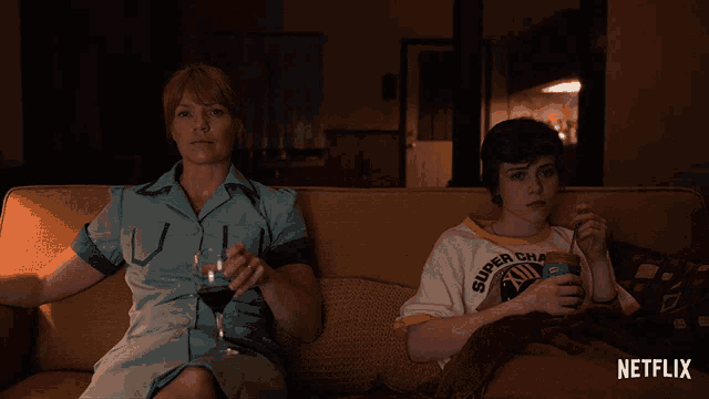a woman and a boy are sitting on a couch with netflix written on the bottom