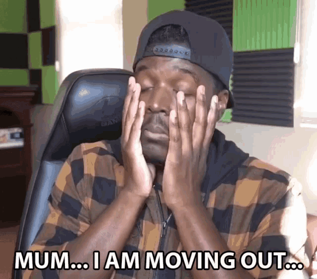 a man sitting in a chair with his hands on his face and the words mum i am moving out