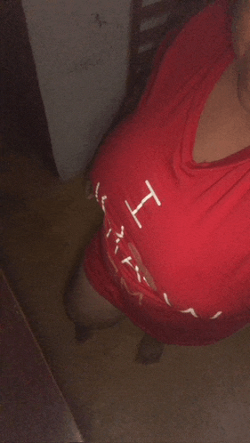 a woman wearing a red shirt that says " i love you "