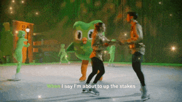 a man and woman are ice skating in front of a green mascot that says when i say