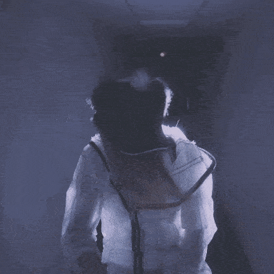 a woman wearing a hat and a white jacket is standing in a dark hallway