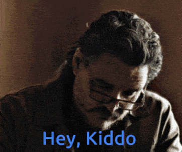 a man wearing glasses and a beard says hey kiddo