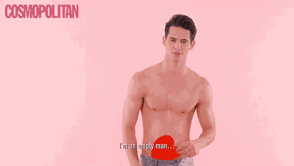 a shirtless man is holding a red object in front of a pink background that says cosmopolitan