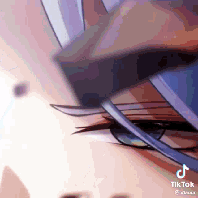 a close up of a person 's eye with a blue ribbon around it .