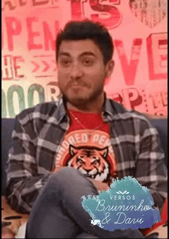 a man wearing a red shirt with a tiger on it