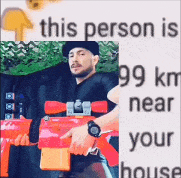 a man is holding a toy gun in his hand and pointing at it .