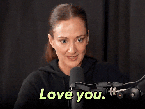 a woman is sitting in front of a microphone and says " love you "