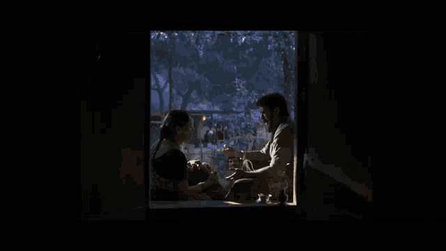 a man is feeding a woman from a bowl