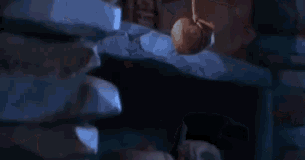 a man is laying on a bed with his arms outstretched and his head down .