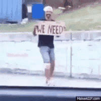 a person holding a sign that says we need