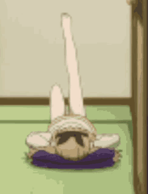 a cartoon girl is laying on her back with her legs up in the air .