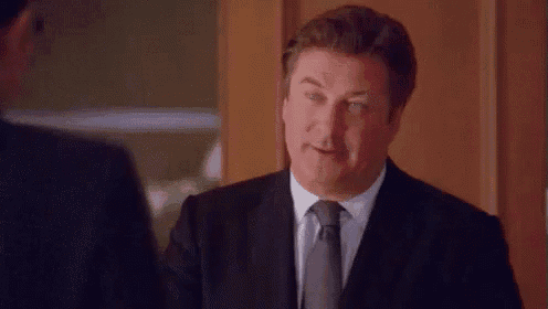 a man in a suit and tie is saying `` i 'm a bear '' .