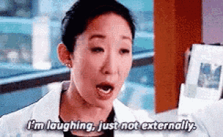 a woman in a lab coat is laughing and saying `` i 'm laughing , just not externally '' .