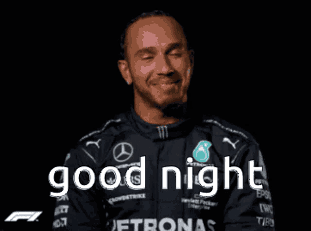 a man in a mercedes uniform is smiling and says good night