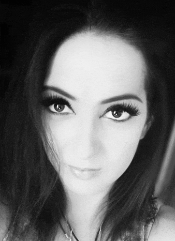 a black and white photo of a woman 's face and eyes