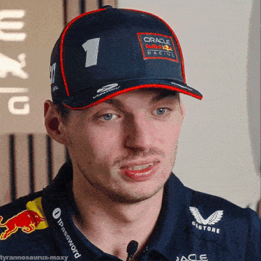 a man wearing a hat that says oracle racing is talking into a microphone