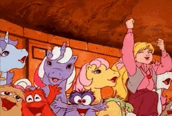 a group of ponies and a girl are sitting next to each other in a cartoon .