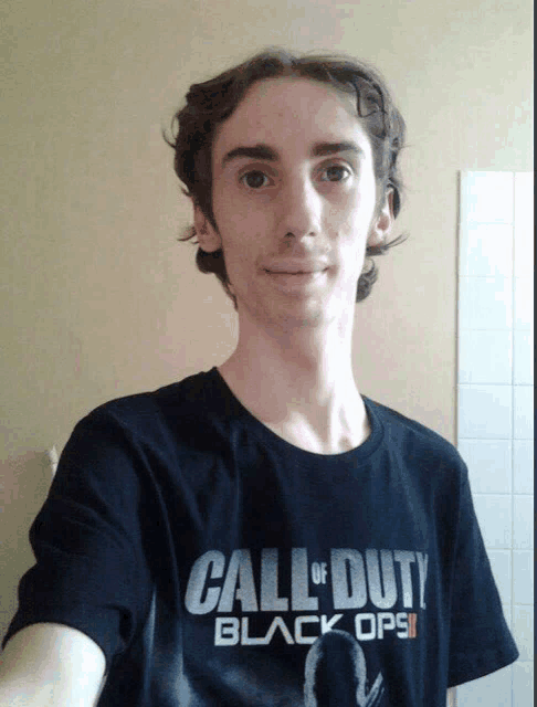 a young man is wearing a black call of duty black ops ii t-shirt