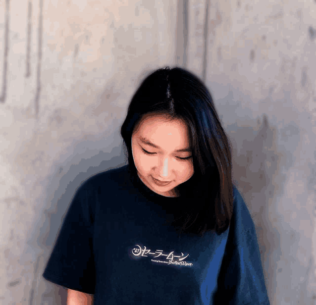 a woman wearing a t-shirt that says sailor moon on it