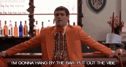 a man in an orange suit is standing in front of a bar .