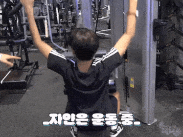a man is using a machine in a gym with korean writing on it