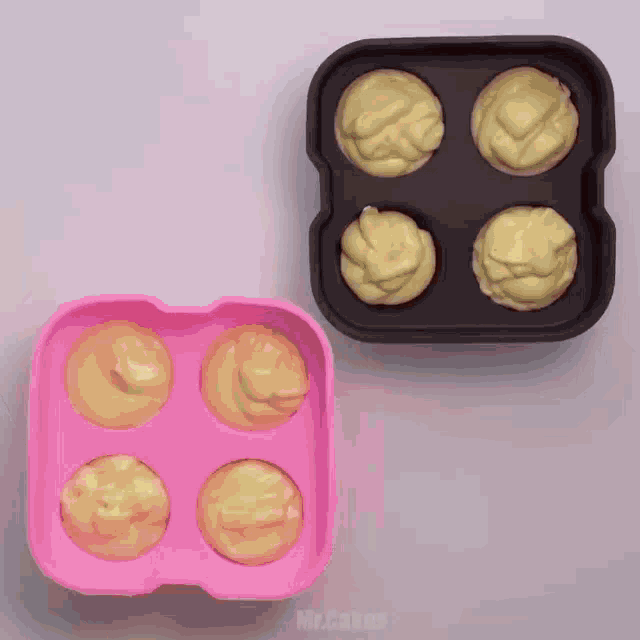 cupcakes are being poured into a pink and black container