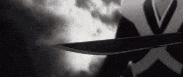 a person is holding a sword in their hand in a black and white photo .