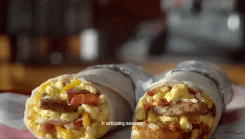 two burritos on a table with the words at participating restaurants