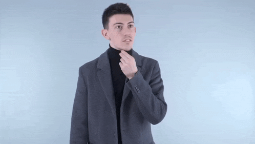 a man wearing a black and white checkered shirt is making a middle finger gesture