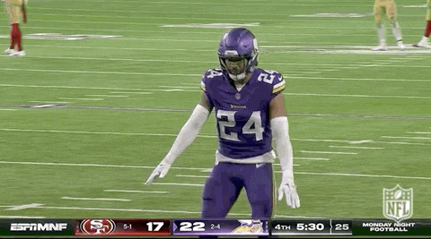 a football player is kneeling down on the field .