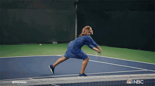 a man holding a tennis racquet on a tennis court with the nbc logo