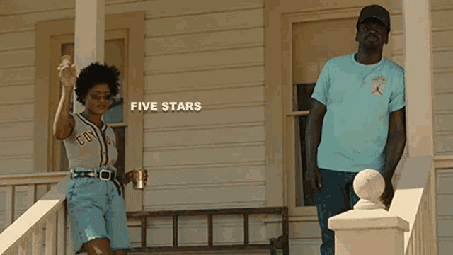 a man and a woman are standing on the porch of a house with the words five stars above them