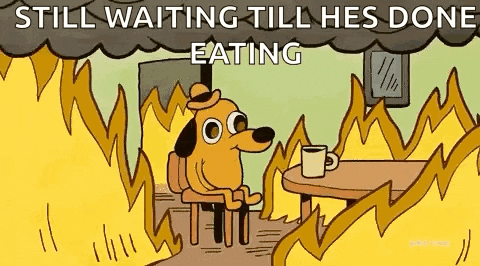 a cartoon of a dog sitting at a table in front of a fire .