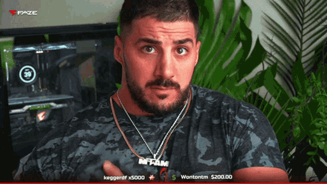 a man with a beard wearing a necklace that says in team