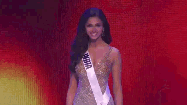 a woman wearing a sash that says india