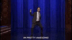 a man in a suit and tie is dancing on stage .