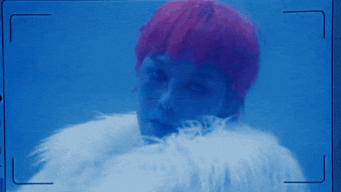 a woman with red hair is wearing a white fur coat in a blue background