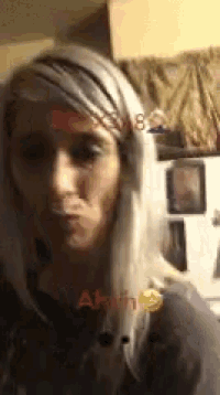 a woman with blonde hair is making a funny face with the letters ahhh visible