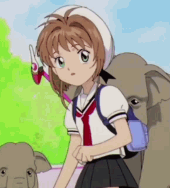 a girl in a school uniform is standing next to an elephant .