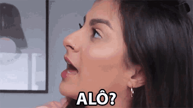 a close up of a woman 's face with the words alo written on it