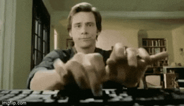 a man is typing on a computer keyboard while sitting at a desk .