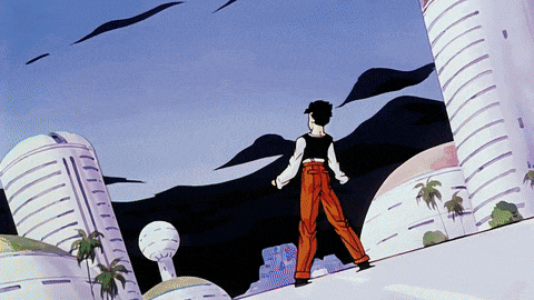 a man in orange pants is standing on a hill in front of a white building
