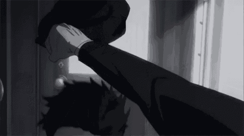 a black and white photo of a person 's hand reaching out towards a door .