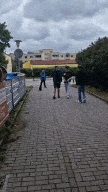 a group of people walking down a brick road