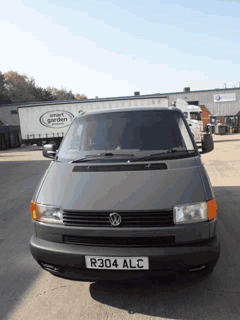 a van with a license plate that says r304 alc is parked in a parking lot
