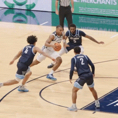 a group of basketball players are playing a game and one of them has the number 2 on his jersey