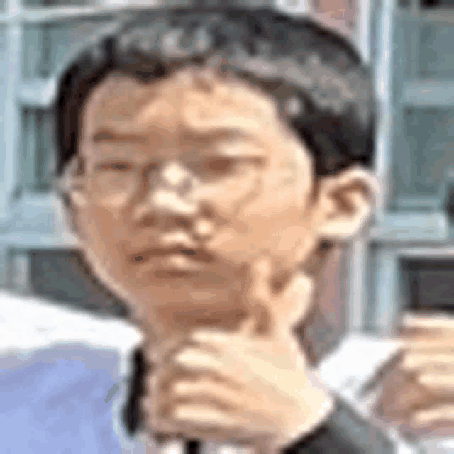 a young boy is giving a thumbs up sign while wearing glasses .