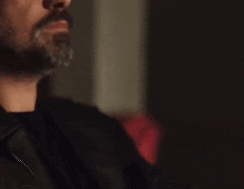 a man with a beard and the words selamun aleykum on the bottom of his face